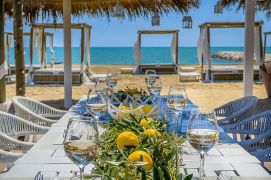 Beach table at Baia Blu Beach Bar, located right in front of Pareus Beach Resort – with views of the beach and sea.